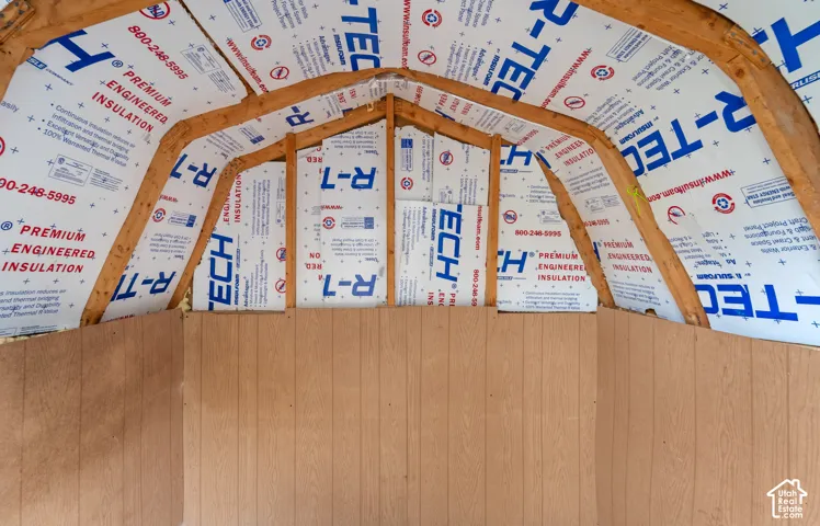 Exposed timber framing with rigid foam insulation panels and wood-panelled wall cladding