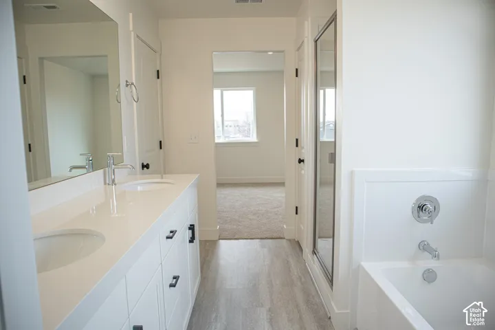Primary bath with separate tub and shower and dual vanity
