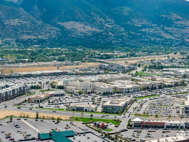 Aerial perspective featuring mountain range backdrop and surrounding commercial district