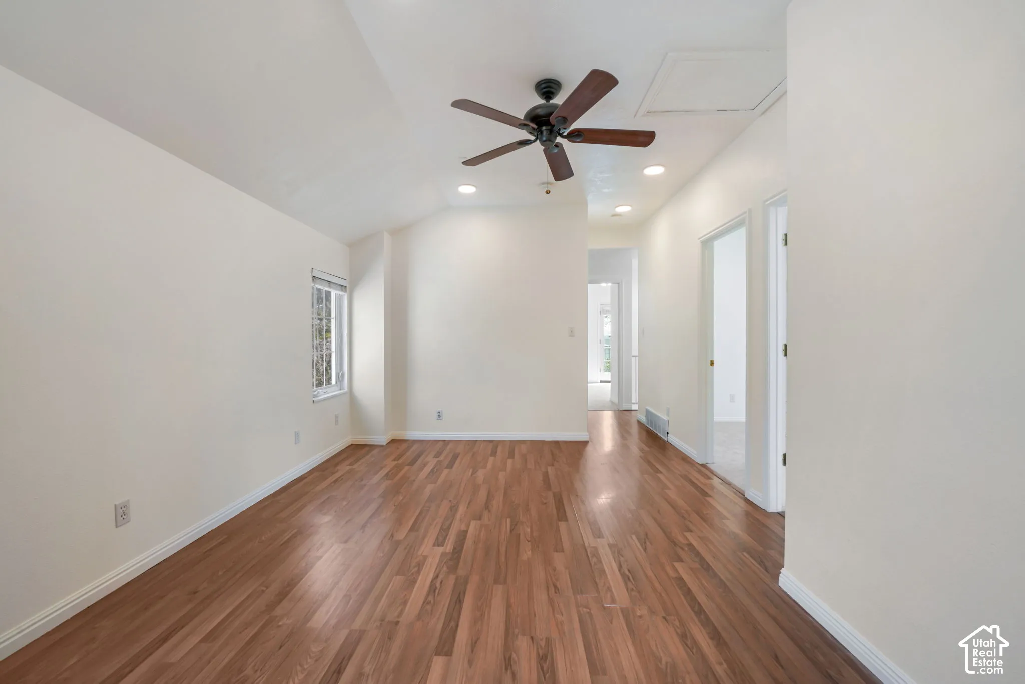 Vaulted ceilings featuring a dark wood-finish ceiling fan, recessed lighting, and wood-finish flooring