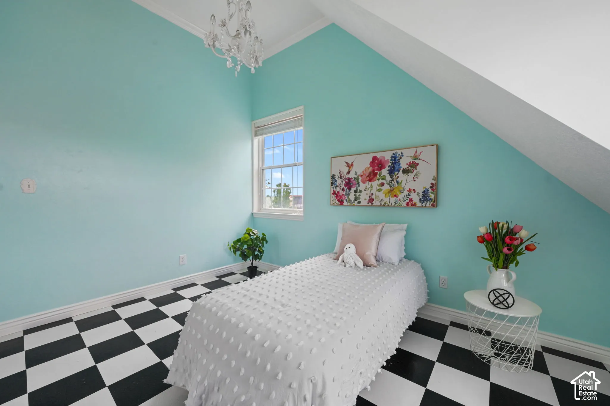 Vaulted ceiling, dual-pane window, and ornate crystal chandelier featuring a monochrome checkerboard floor finish