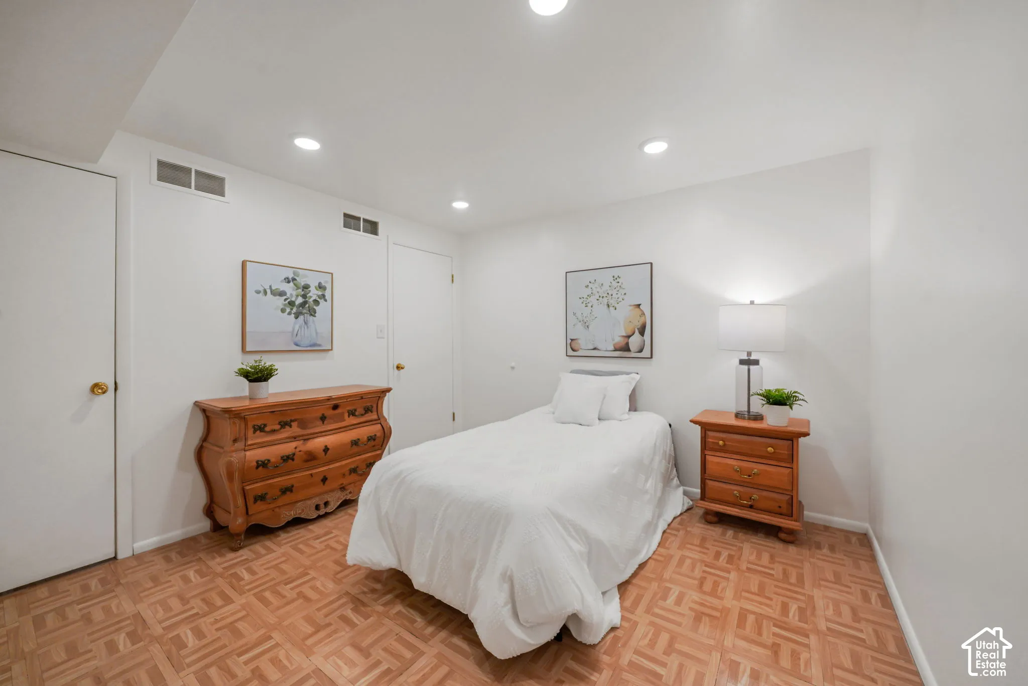 Room featuring parquet wood-finish flooring, recessed lighting, and neutral wall tones