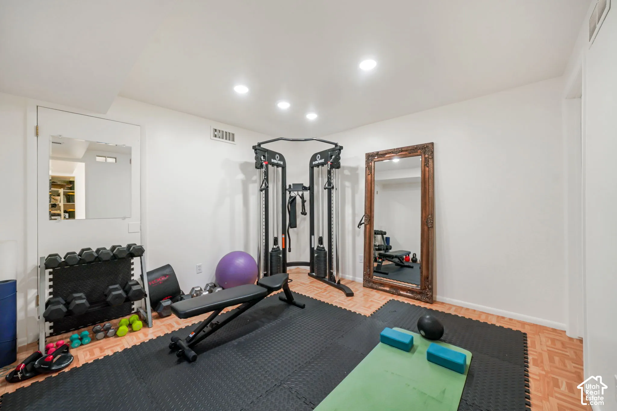 Interior space featuring parquet wood-finish flooring and recessed ceiling lighting