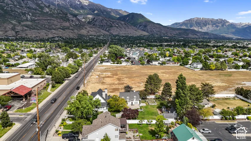 Expansive parcel of land featuring mountain backdrops and established perimeter trees