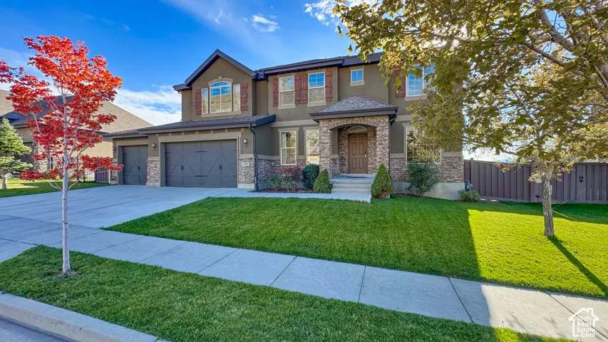 Two-story exterior featuring a stone and stucco fa