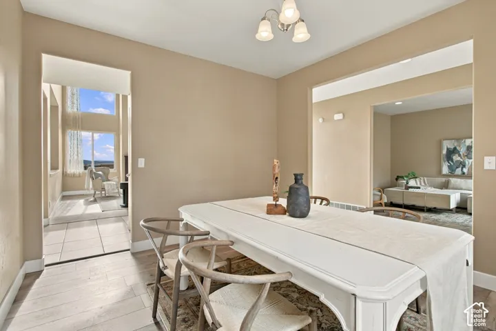 Neutral-toned interior space with wood-finish flooring and three-light ceiling-mounted fixture