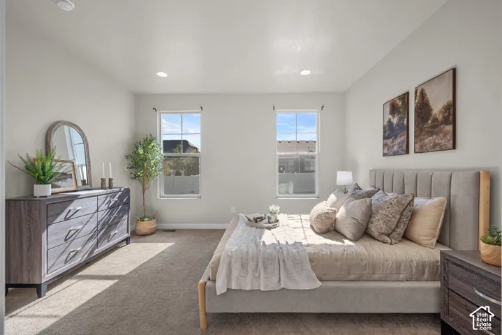 Neutral-toned room featuring recessed lighting, plush wall-to-wall carpeting, and two double-hung windows