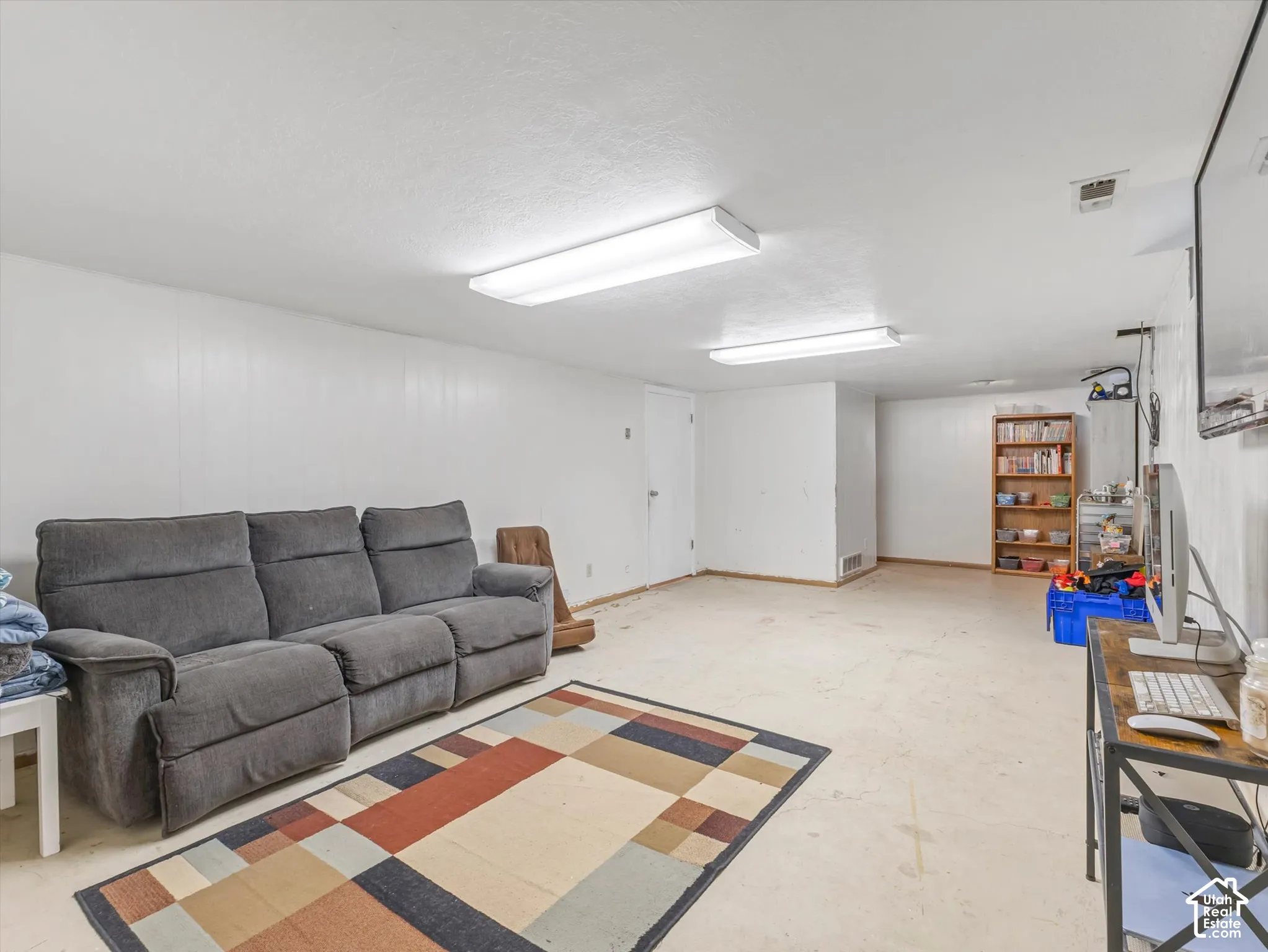 Interior space featuring smooth finished walls and dual rectangular ceiling-mounted light fixtures