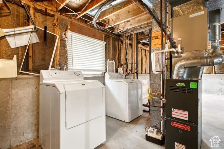 Unfinished utility space featuring exposed wood-stud framing, concrete foundation walls, a pleated window blind, and a mechanical furnace system