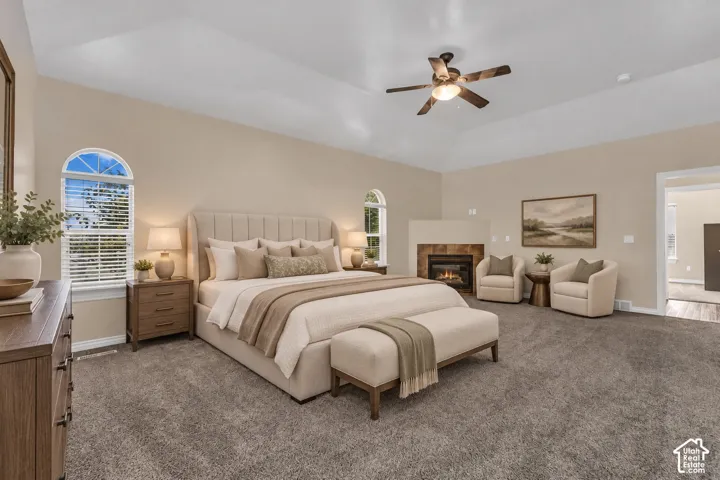 Vaulted ceilings, arched windows, and a built-in corner fireplace featuring tile surround