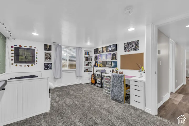 Interior space featuring plush carpeting, recessed lighting, and built-in shelving