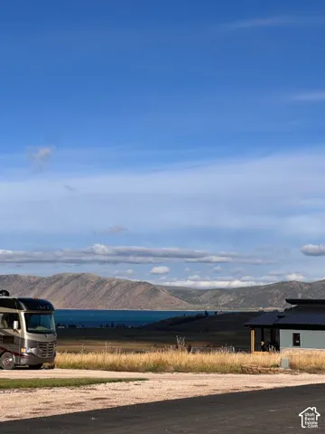 Expansive natural scenery featuring a water body and mountain backdrop