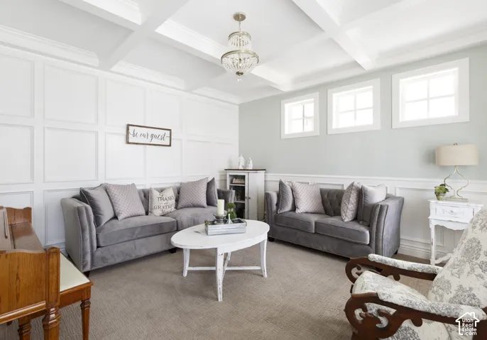 Coffered ceiling with a center chandelier, grid-patterned wall millwork, and three clerestory windows