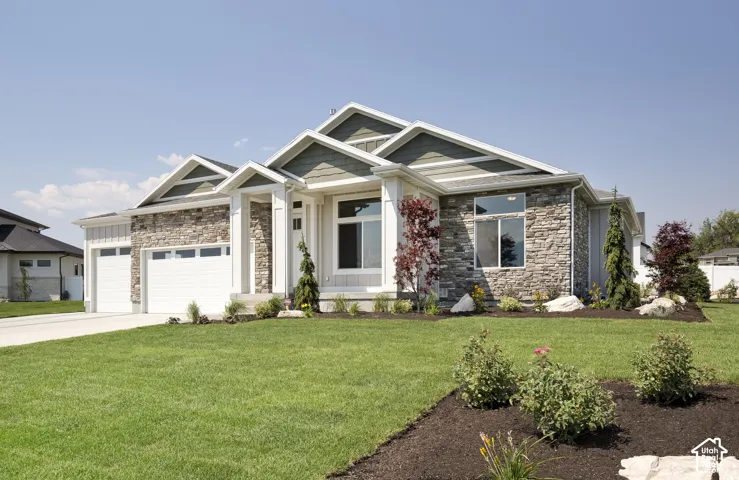 Single-story exterior featuring multi-gabled rooflines, stone veneer facade, horizontal siding, and an attached multi-car garage