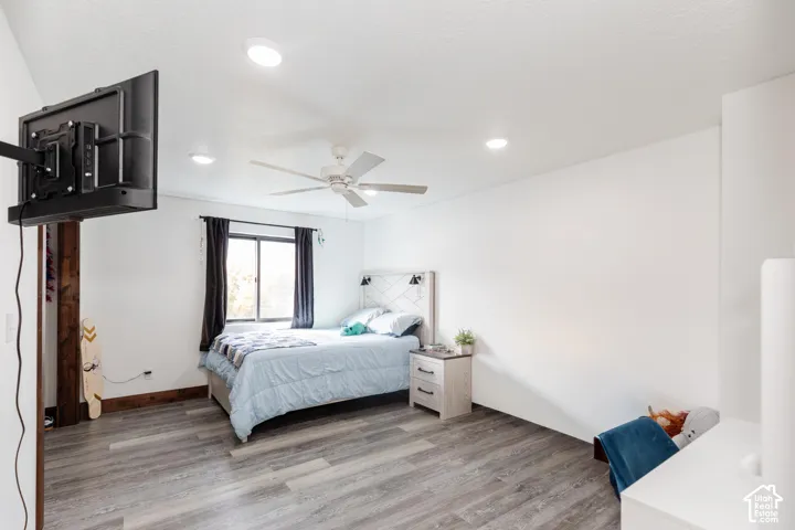 Room featuring wood-finish flooring, recessed lighting, and a ceiling fan