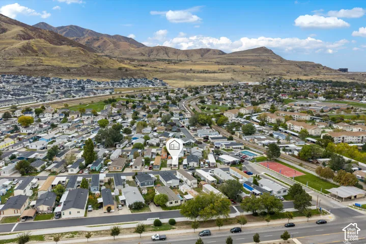 Aerial perspective of a residential property set against a mountain range backdrop