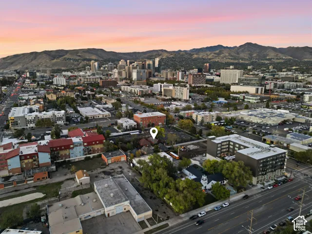 Aerial perspective featuring a prominent mountain backdrop and central urban location