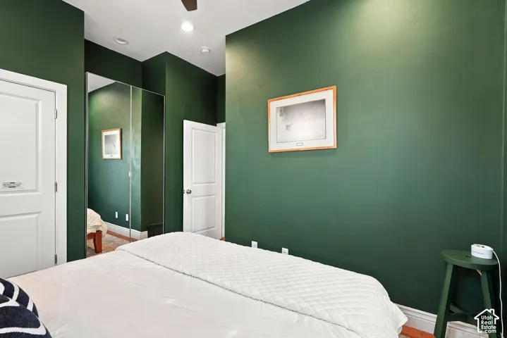 Room featuring full-height mirrored closet doors, recessed ceiling lighting, and solid-core interior doors