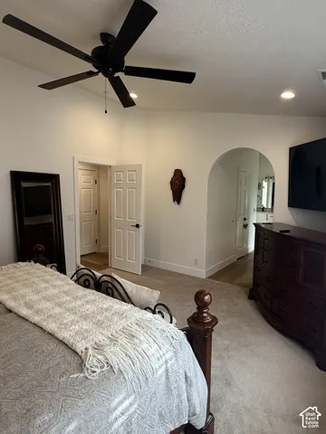 Vaulted ceilings, arched architectural detailing, matte black ceiling fan, and recessed lighting