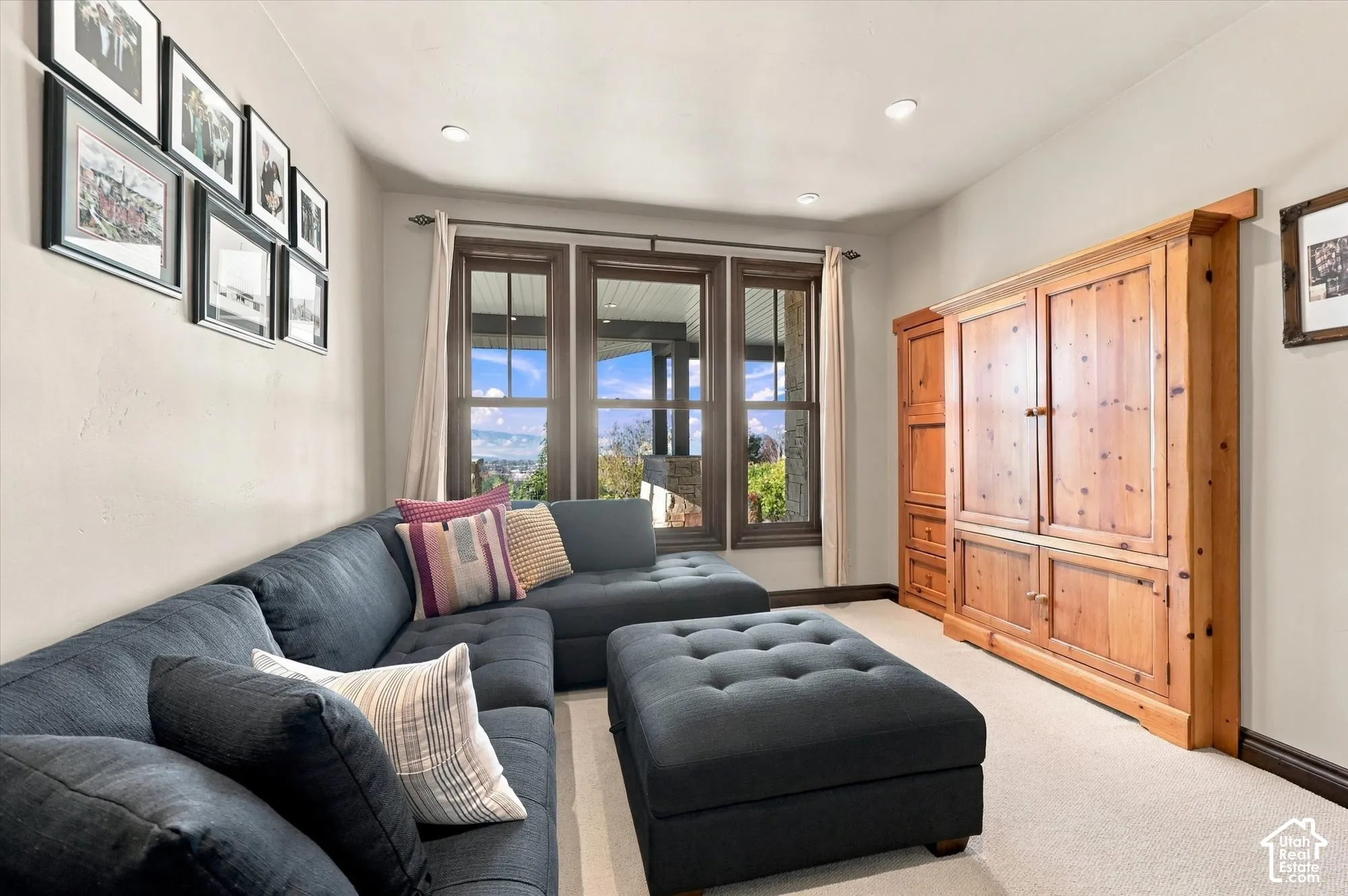 Built-in wood cabinetry, three-paneled windows with dark trim, and recessed lighting