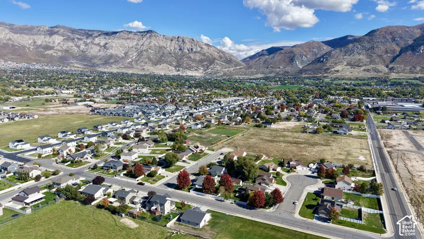 Aerial perspective featuring a residential subdivision grid situated against a prominent mountain range backdrop