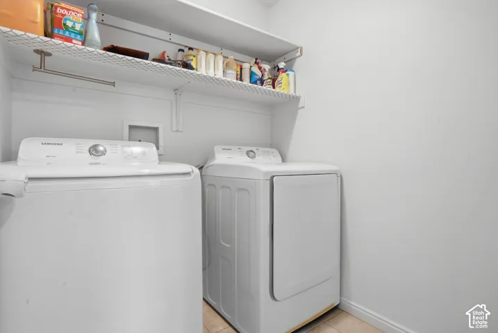 Laundry area featuring built-in wire shelving and tile flooring
