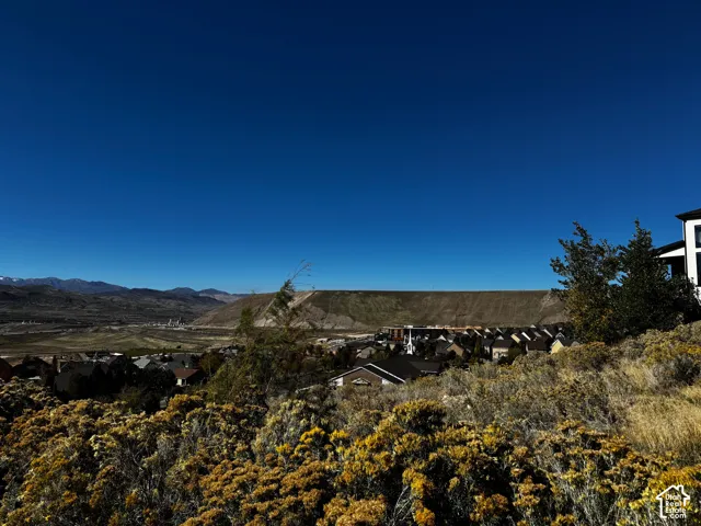 Panoramic desert landscape featuring expansive mountainous terrain, native shrubbery, and high-altitude surroundings