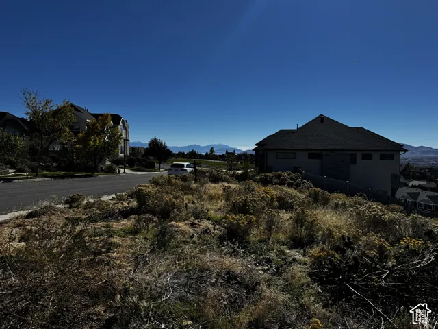 Undeveloped hillside lot featuring native shrubbery and mountain backdrops