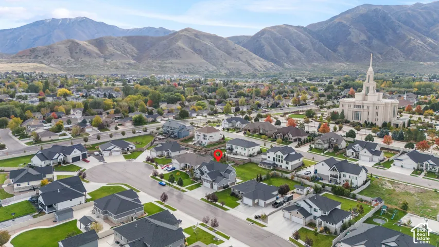 Aerial perspective featuring mountainous horizon and established residential surroundings