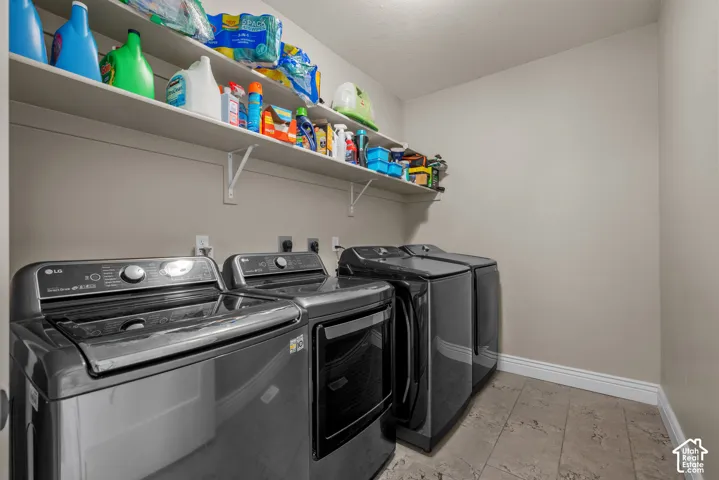 Utility area featuring tile flooring and integrated wall-mounted shelving