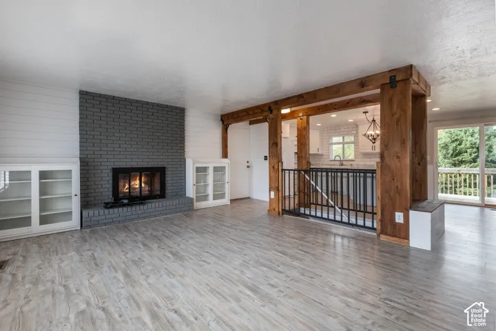 Bright living room with updated flooring, gas fireplace and plenty of natural light.