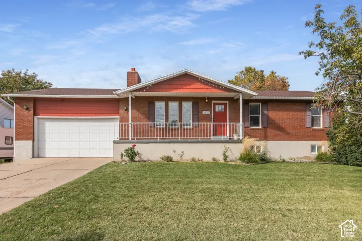 Classic brick rambler with a welcoming covered front porch and 2-car garage.