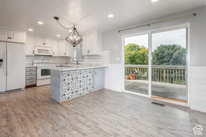 Updated kitchen with abundant cabinetry, center island and easy access to the deck.