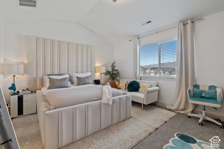 Vaulted ceiling, neutral wall tones, and large horizontal window with slatted blinds