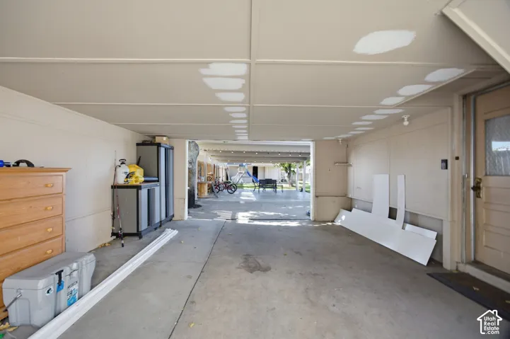 Covered carport featuring a concrete floor and a single exterior entrance door