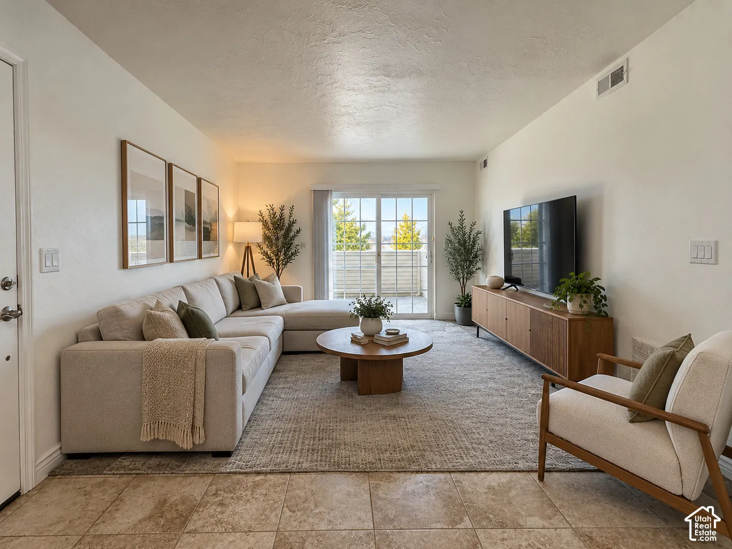 Room featuring neutral walls, large-format tile flooring, and sliding glass doors with exterior access