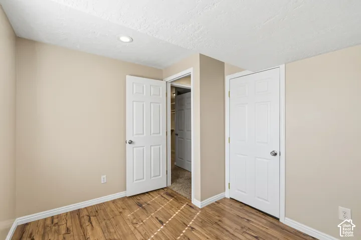 Wood-finish flooring, recessed lighting, and interior six-panel doors