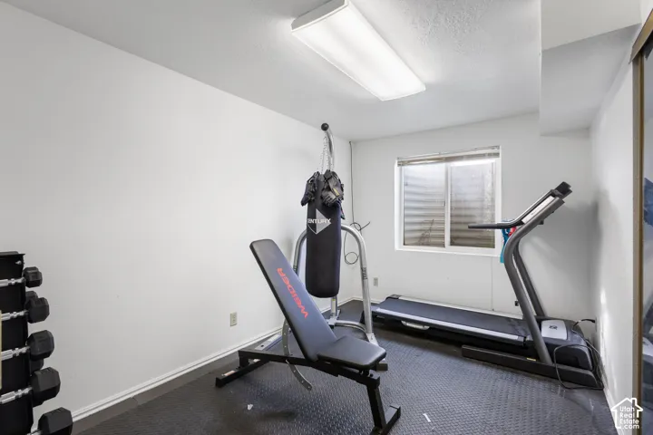 Room featuring white walls, a flush-mount rectangular light fixture, and a sliding-door closet