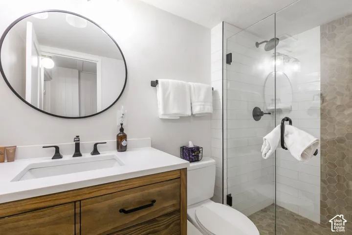 Wood-finish vanity with a white countertop and undermount sink