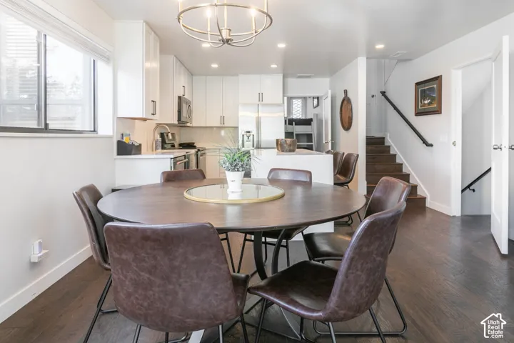 Kitchen featuring white cabinetry, stainless steel appliances, and a tiled backsplash