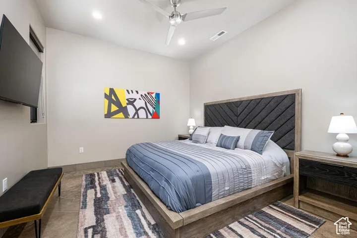 High-ceiling room featuring neutral wall tones, recessed lighting, and a brushed nickel ceiling fan
