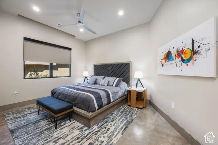 Neutral wall color, polished concrete flooring, recessed lighting, and a modern ceiling fan