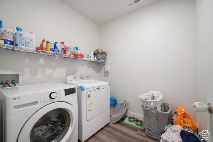 Laundry room featuring wood-finish flooring and wire wall-mounted shelving