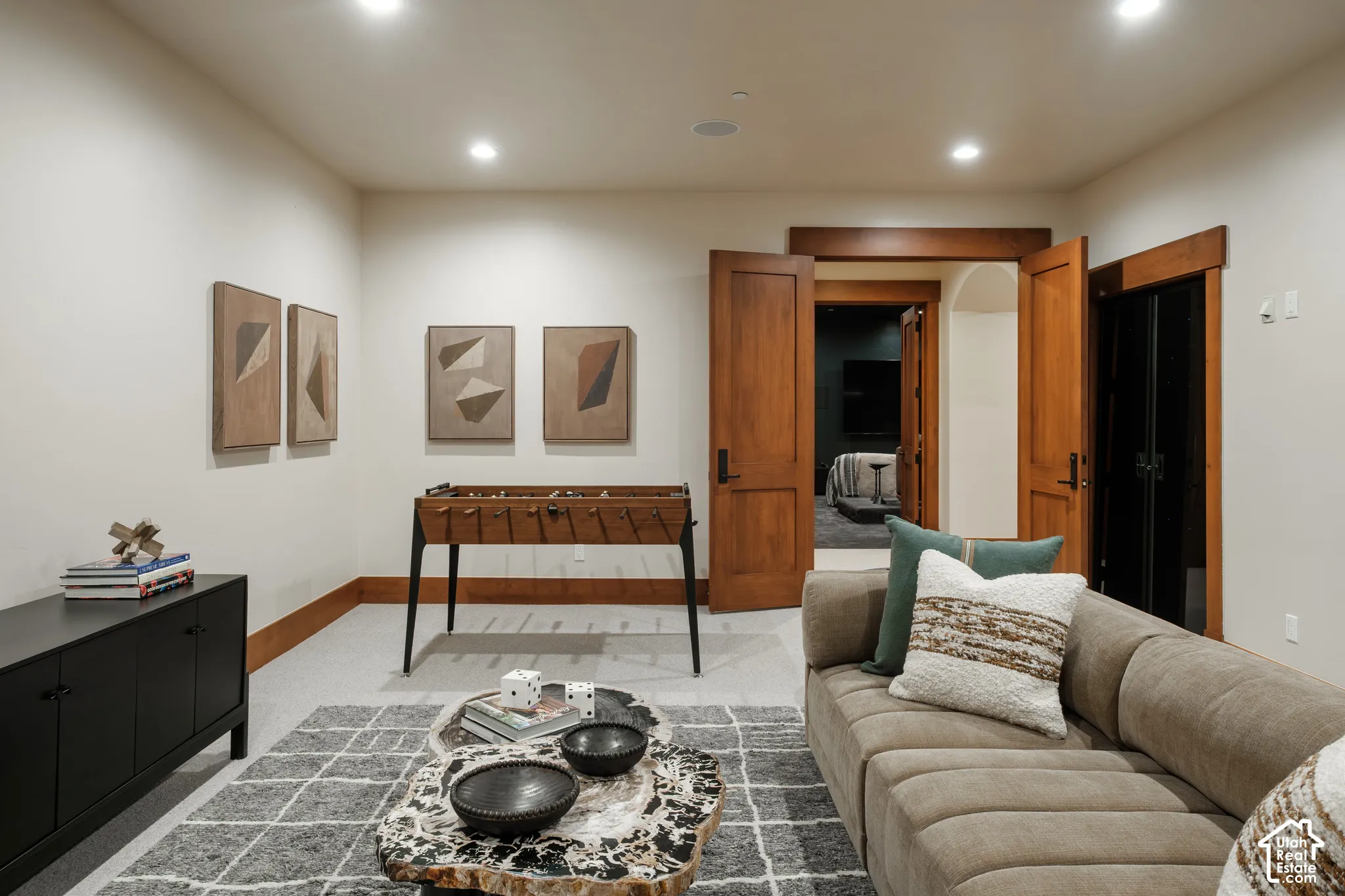 Neutral-toned interior space featuring recessed ceiling lighting, solid wood interior doors, and prominent wood door casing