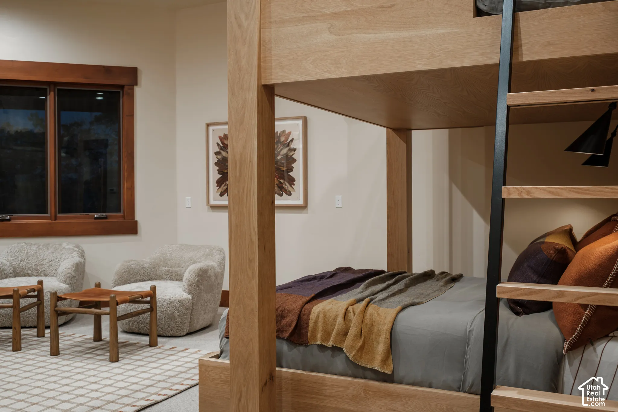 Spacious room featuring wood-trimmed window casing, high ceilings, and neutral wall tones