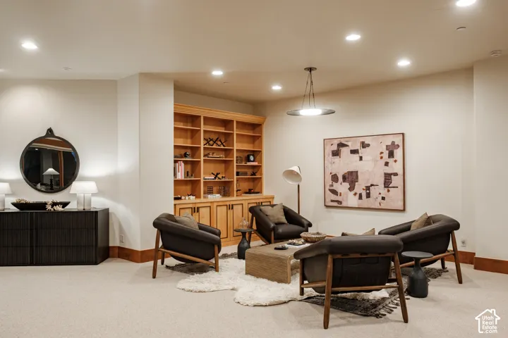 Custom built-in wood cabinetry with shelving, recessed lighting, and a pendant fixture