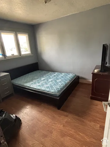 Room featuring wood-finish flooring and dual-pane windows with trim