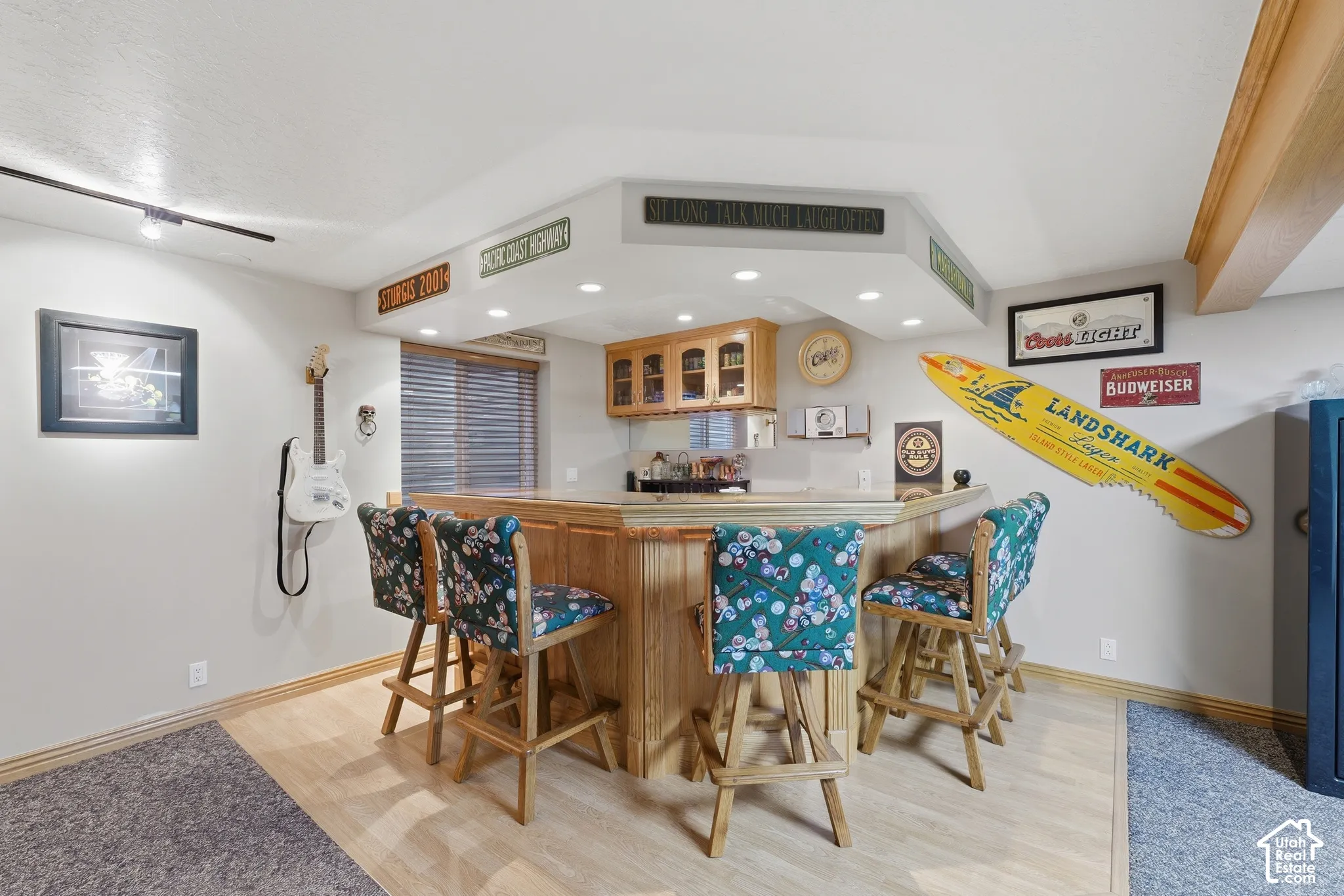 Built-in wet bar featuring a wooden counter, recessed lighting, upper cabinetry, and a mirrored backsplash