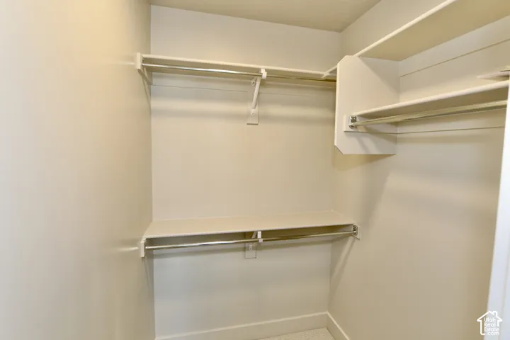 Bedroom #3 Walk-in closet featuring multi-level hanging rods and integrated upper shelving