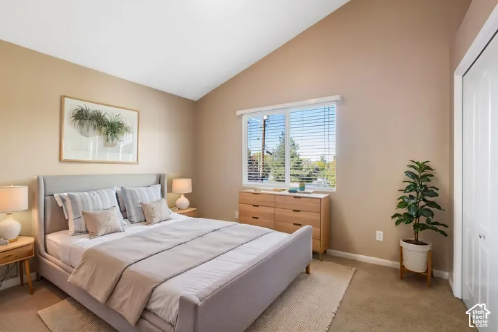 Vaulted ceilings and expansive single-pane window with horizontal blinds